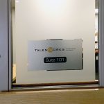 Door with branded window film and signage